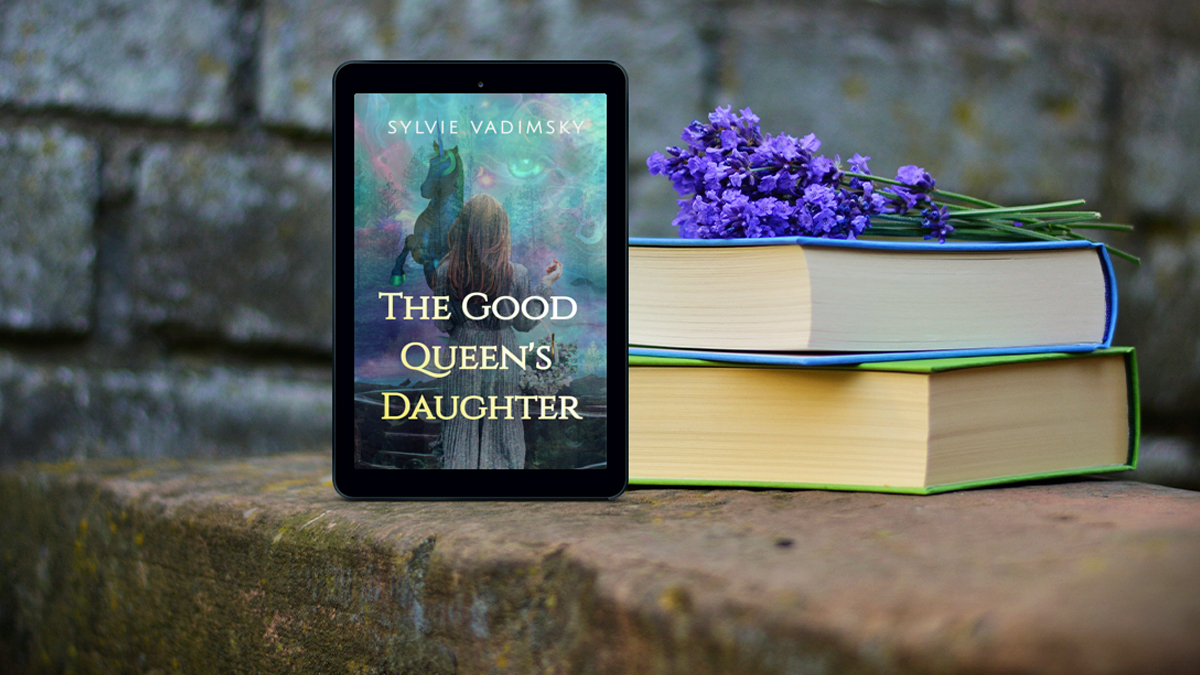 wooden table against a stone wall displays two stacked books with a sprig of lilac flowers on top, next to a tablet displaying The Good Queen's Daughter book cover with blues and purples